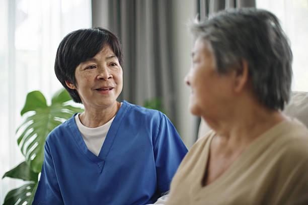 istock Nurse having a relaxed conversation with an elderly patient at home. 2235895701