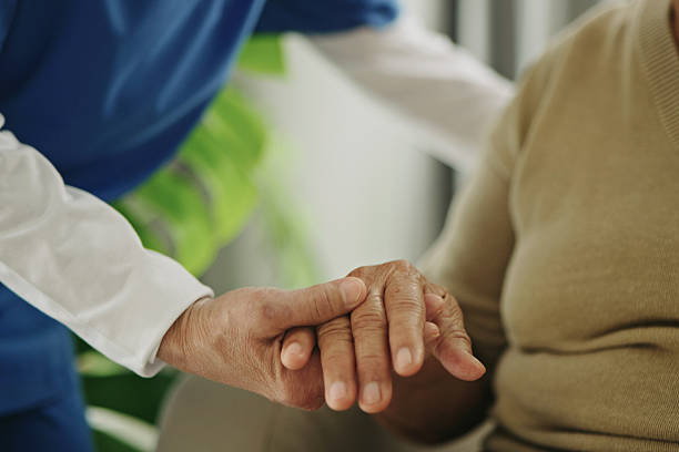 istock Home caregiver helping a senior woman standing. 2235896377