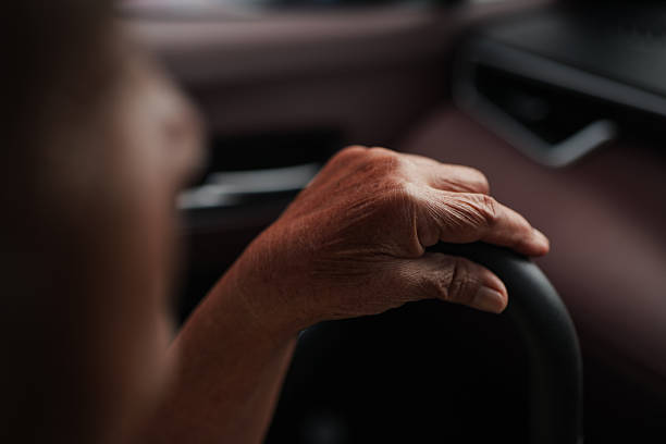 istock Senior holding a walking cane while traveling in a car. 2235897759