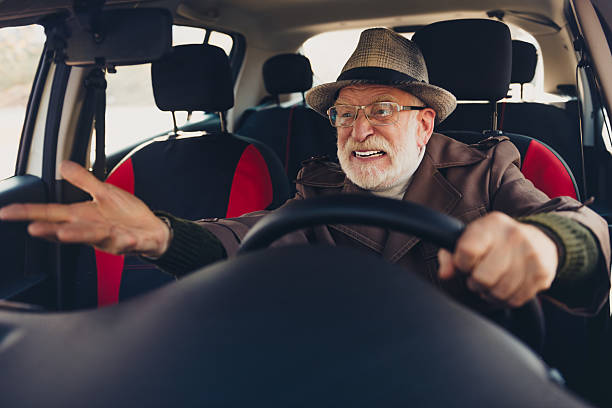 istock Elderly man animatedly gestures while driving car, showcasing emotion and energy inside modern vehicle 2235899735