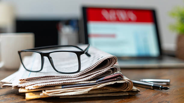 istock business woman using tablet pc for reading news 2235900542