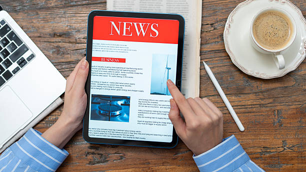 istock business woman using tablet pc for reading news 2235900719