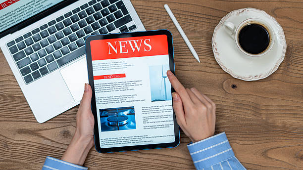 istock business woman using tablet pc for reading news 2235900907