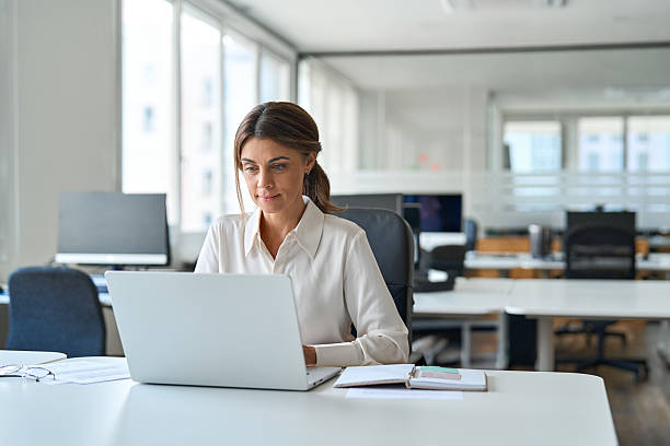 istock Busy middle aged business woman executive using laptop working in office. 2235903564