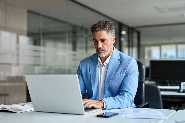 istock Focused busy middle aged professional business man using laptop in office. 2235903624