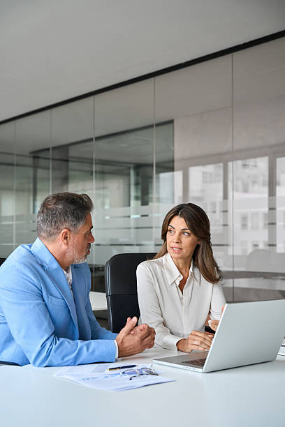 istock Two busy business man and woman executives using laptop working in office. 2235903706