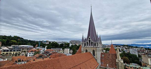 Lausanne, Switerland - September 1, 2025: View of Lausanne with cathedral in foreground and cloudy sky