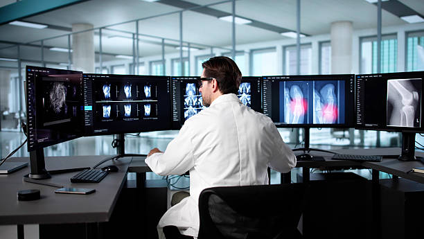 istock Senior Radiologist Analyzing X-Ray Image Of Elderly Man's Knee 2235904817