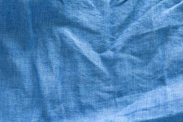 istock A close-up of a textured, deep blue linen fabric with wavy. abstract background design. 2235907071