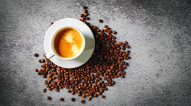 istock Coffee cup and coffee beans on gray background, Espresso crema coffee cup aromatic, top view 2235907746