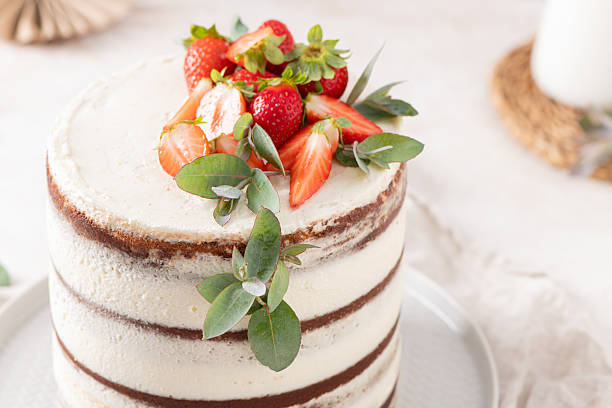 istock Appetizing semi-naked cake featuring creamy layers, fresh strawberries, and eucalyptus decor, perfect for any sweet celebration 2235908086