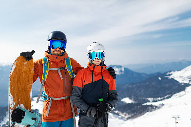 istock Father and son skiing and snowboarding in mountain 2235908861