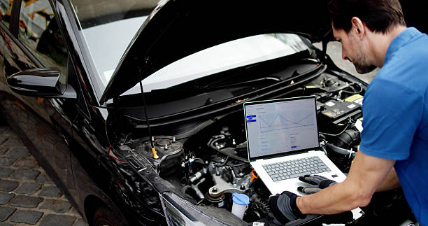 istock Skilled Mechanic Using Laptop To Diagnose Car Issues In Garage 2235908891