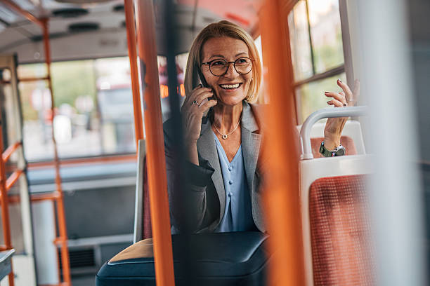 istock Senior businesswoman talking on phone while riding bus 2235909748