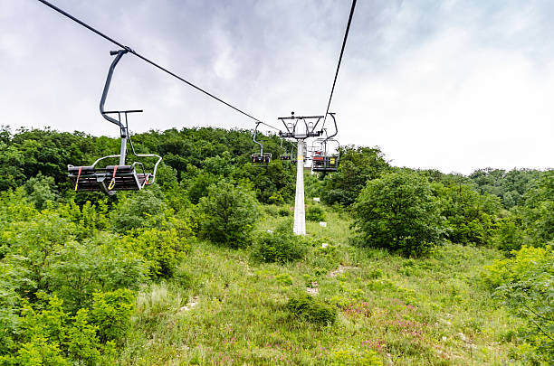 istock Cable car tower on lush green mountainside 2235909830