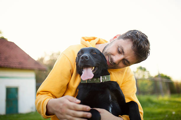 istock Young man is playing with a dog 2235909842