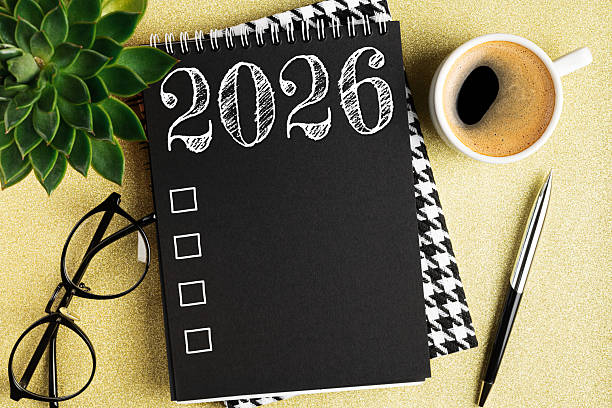 istock New year resolutions 2026 on desk. 2026 resolutions list with notebook, coffee cup on table. Goals, resolutions, plan, action, checklist concept. New Year 2026 template, copy space 2235910847