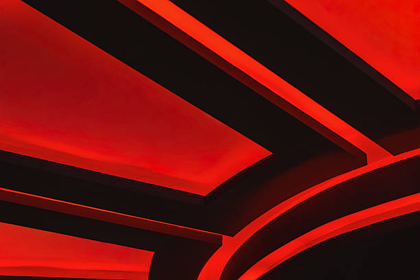 istock Red illuminated ceiling design with glowing geometric lines in a dark interior. Concept of cinema, architecture, modern design. Bright background 2235911354