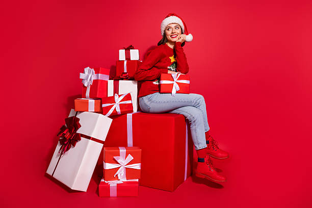 istock Photo of sweet charming young lady dressed print pullover preparing christmas presents looking empty space isolated red color background 2235912666