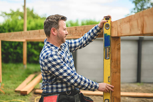 istock Handyman worker making patio outside close to a pool using level 2235912897