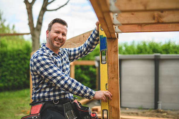 istock Handyman worker making patio outside close to a pool using level 2235912900