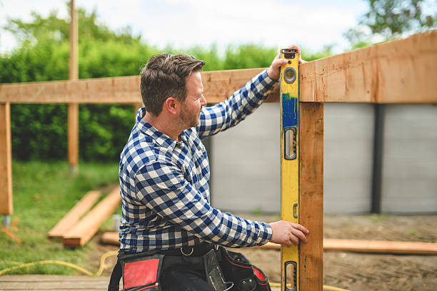 istock Handyman worker making patio outside close to a pool using level 2235912903