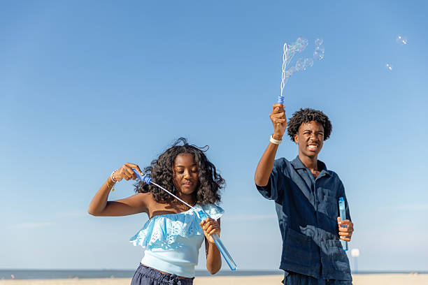 A beautiful diverse family made up of two children enjoying a sunny day on the beach in the Netherlands