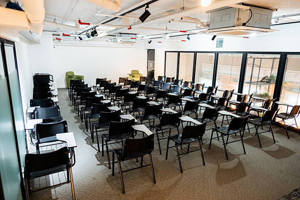 istock Modern classroom with tiered seating and writing desks 2235913624