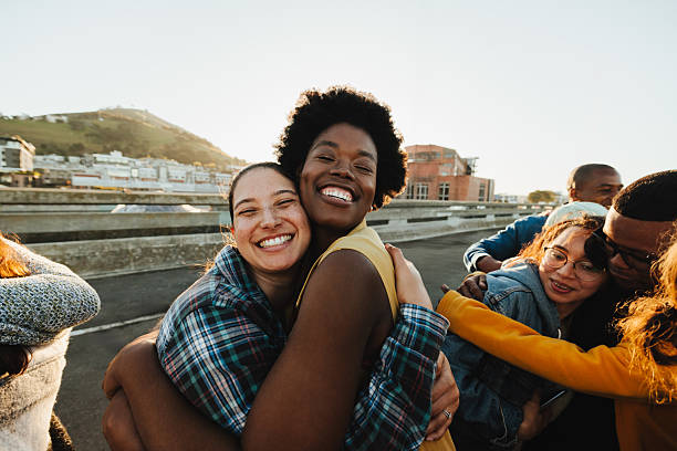 istock Young adults embracing outdoors with joyful expressions 2235917924