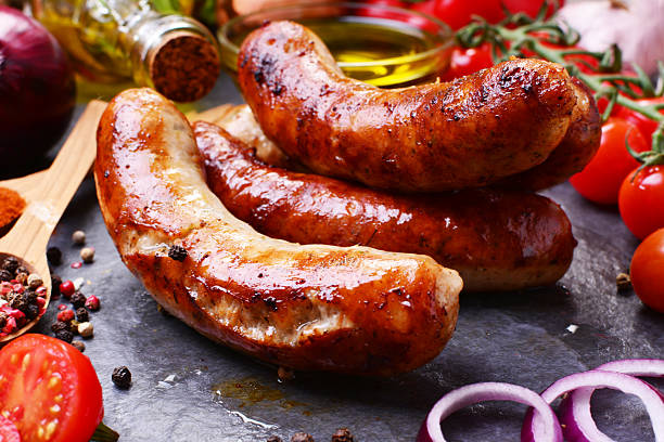 istock Pork sausages with spices and vegetables 2235918097