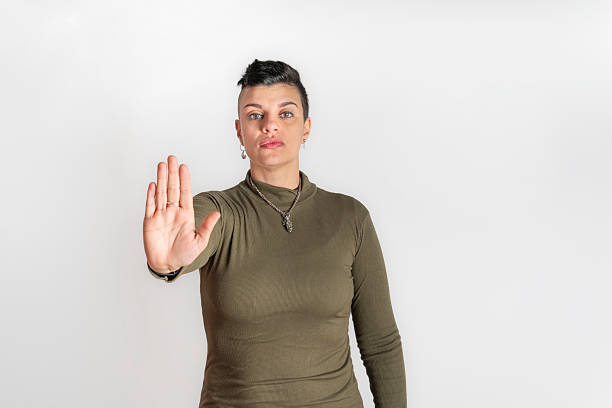 istock Woman holding up her hand in a stop gesture 2235919725