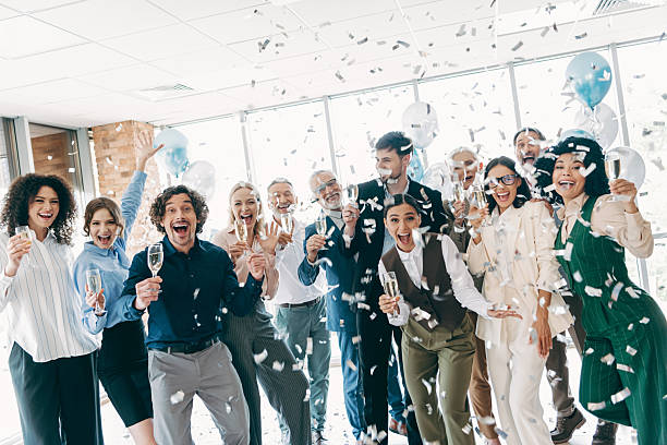 istock Celebratory business team throwing confetti and cheering in a modern office environment with bright ambiance 2235919862