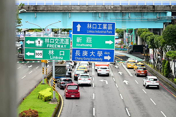 Guishan, Taiwan - Jul 21, 2025: Multi-directional road signage indicating Linkou Industrial Park north, Freeway interchange left, and Xinzhuang with Chang Gung University 4km right.