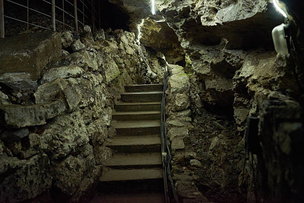 istock Stone Steps Ascending through Underground Cave Passage with Rocky Walls 2235921340