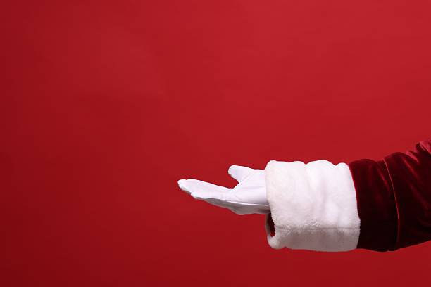istock Santa Claus holding something on red background, closeup. Space for text 2235924511