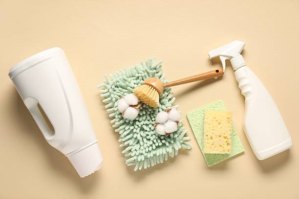 istock Cleaning products and tools on beige background, flat lay 2235925405
