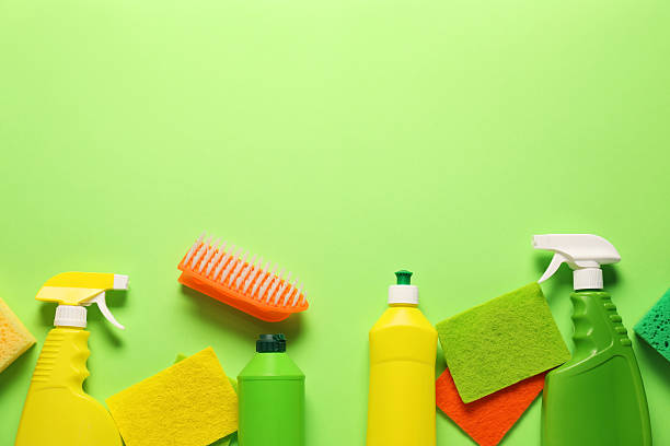 istock Cleaning products and tools on green background, flat lay. Space for text 2235925593