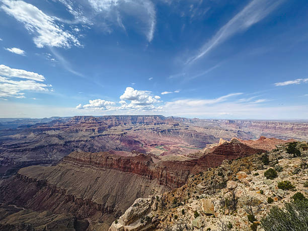Panoramic view of the Grand Canyon with dramatic cliffs, layered rock formations, and vast open sky. Iconic desert landscape symbolizing adventure, exploration, and natural wonder.