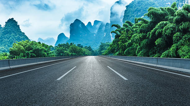 istock Empty asphalt highway road and majestic karst mountain with green bamboo forest natural landscape in Guilin, China. 2235926513