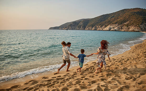 istock A family run down a tropical paradise beach during sunset 2235926565