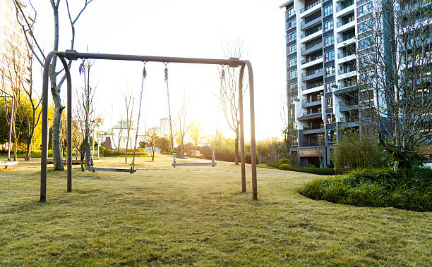 Two empty swings with chains in a Chinese residential area park