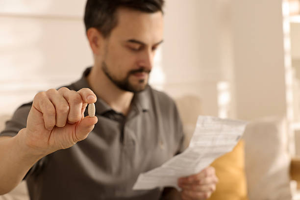 istock Man with pill reading instruction at home, selective focus 2235927189