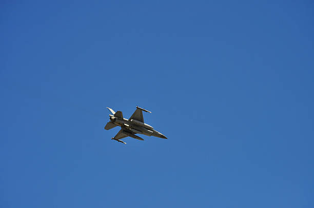 Close-up of F-16 Fighter jet aircraft flying at sunset.