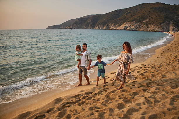 istock A family run down a tropical paradise beach during sunset 2235927781