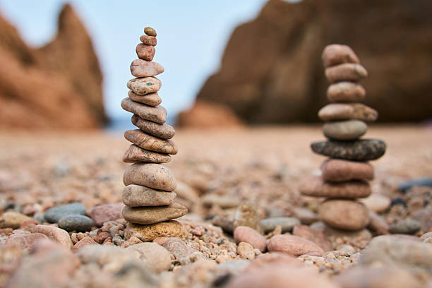 Stone stacks on a pebble beach evoke a sense of peace and balance.