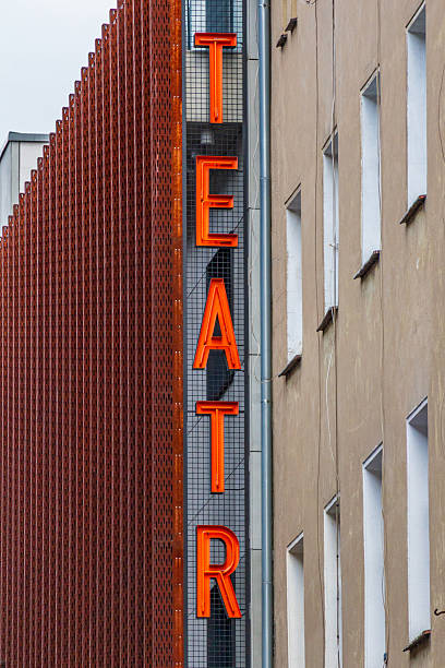 istock Vertical neon sign with the word TEATR on modern building facade 2235931190