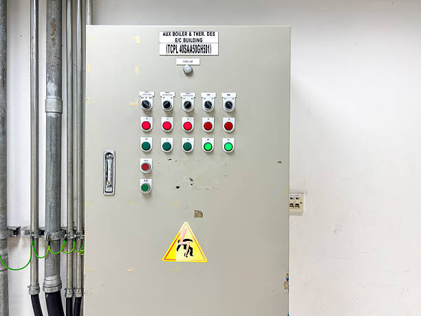 istock Industrial Control Panel with Hazard Sign and Plumbing Pipes System in Facility Interior shows Power Switches and Gauges Electrical Power Unit Installation for Safety Awareness Concept 2235931533