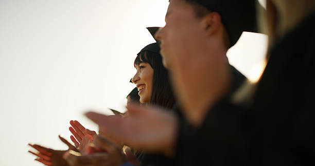 istock Woman, applause or students with celebration, graduation or congratulations with ceremony. People, college or achievement with smile, clapping or university award with education, success or cheering 2235933716