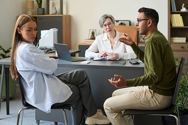 Woman Psychologist Facilitating Conversation between Adults