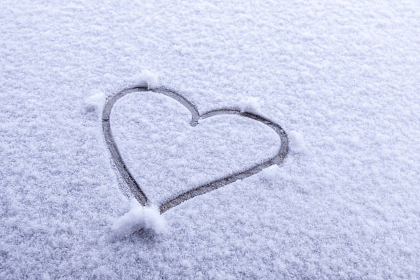 istock Hand-drawn heart shape etched into fresh pristine snow, symbolizing winter romance, love, Valentine's Day, and seasonal affection 2235934851